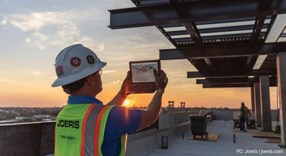 construction worker using BIM 360 to access design files at a work site