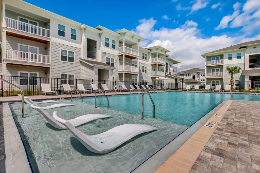 Pool and apartments at the Exchange at Orange Park garden apartments in Jacksonville, Florida.