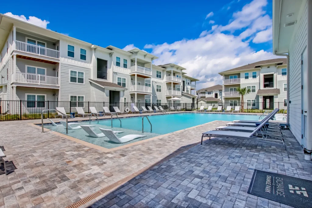 Pool and apartments at the Exchange at Orange Park garden apartments in Jacksonville, Florida.