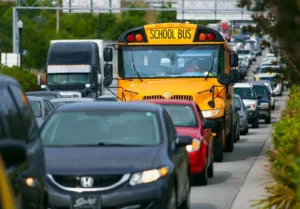 A school bus sits in traffic. 