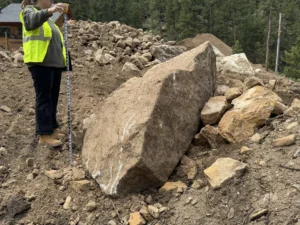 A large boulder on a construction site. 