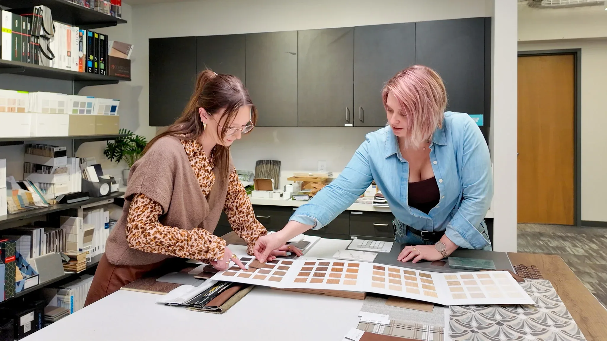 Interior Designers Nicole Desjardins and Emily Oberrieder work on creating a materials palette for a hospitality project.